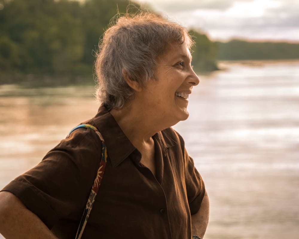 Side profile of a senior lady laughing.